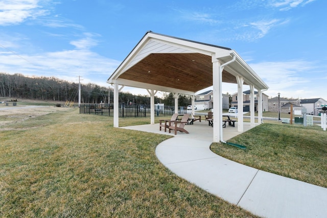 view of home's community with a lawn and fence