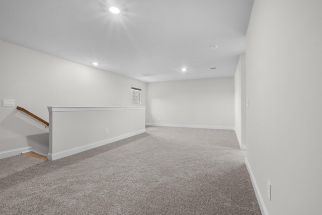 carpeted empty room featuring recessed lighting and baseboards