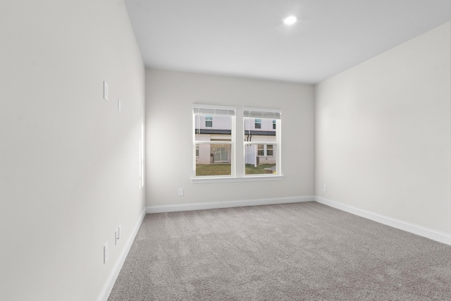 spare room featuring recessed lighting, baseboards, and carpet