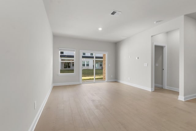 unfurnished room with recessed lighting, light wood-style floors, visible vents, and baseboards