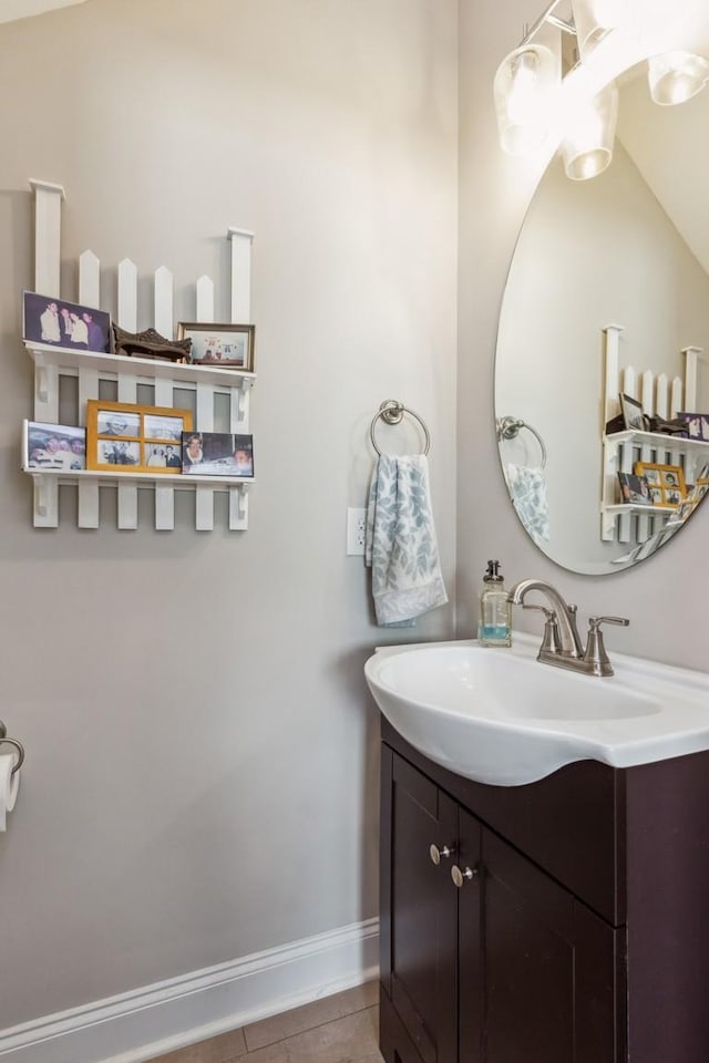 bathroom with tile patterned flooring, vanity, and baseboards