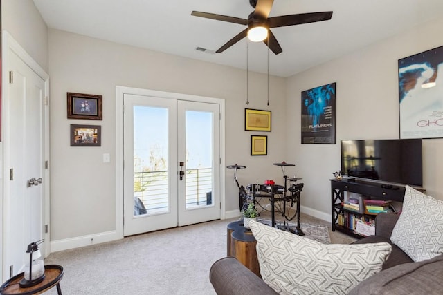 carpeted living area with visible vents, baseboards, ceiling fan, and french doors