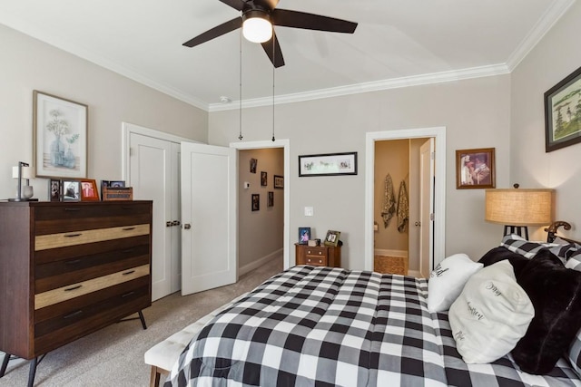 bedroom featuring ensuite bath, crown molding, ceiling fan, and light carpet