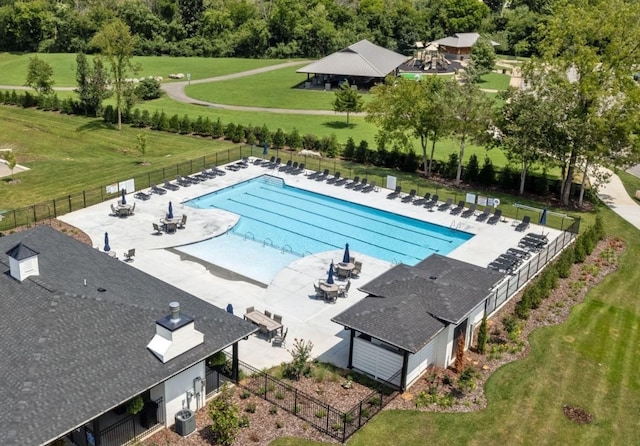 pool with a patio and fence