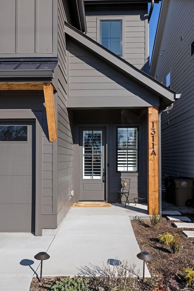 view of exterior entry with a garage