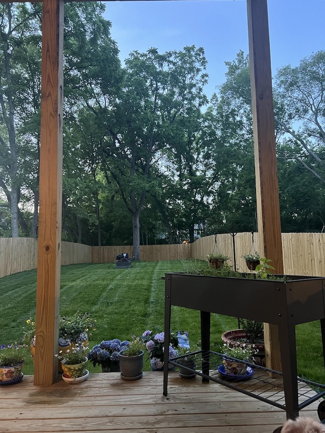 view of yard featuring a wooden deck and fence