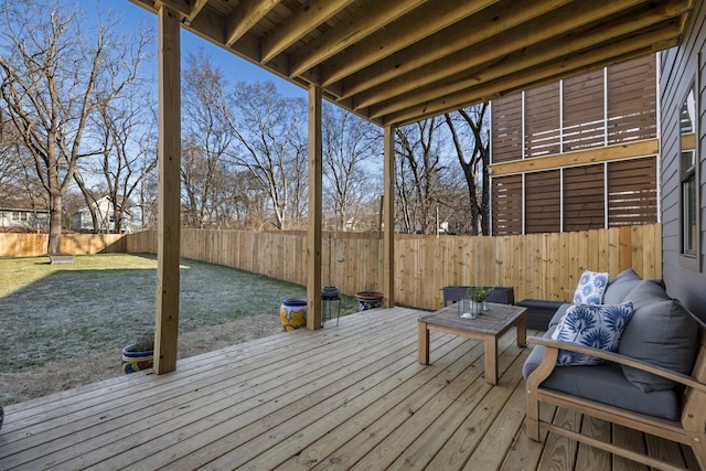 wooden deck with a fenced backyard