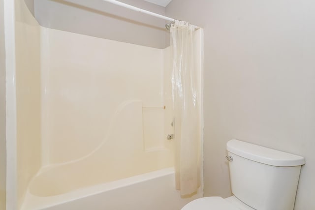 bathroom with toilet and shower / tub combo