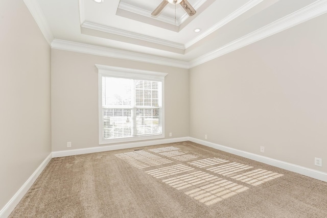 carpeted empty room featuring baseboards, ceiling fan, and ornamental molding