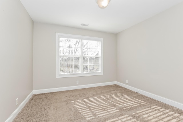 unfurnished room featuring carpet flooring, baseboards, and visible vents