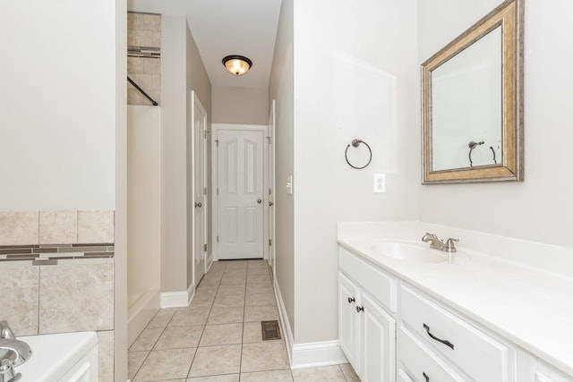 full bathroom with visible vents, baseboards, a bathtub, tile patterned floors, and vanity