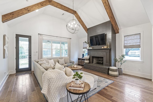 living room featuring hardwood / wood-style floors, beam ceiling, a fireplace, and high vaulted ceiling