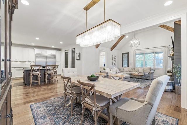 dining area featuring recessed lighting, light wood-style floors, a notable chandelier, and vaulted ceiling with beams