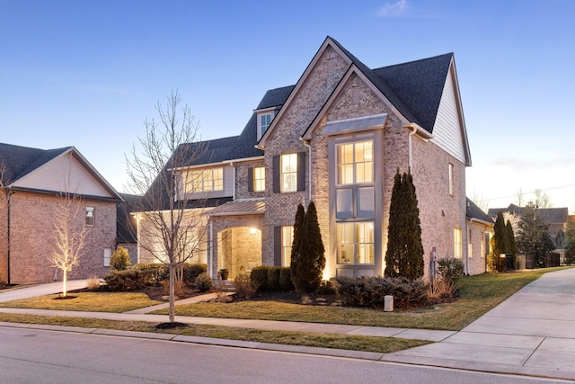 traditional home featuring brick siding