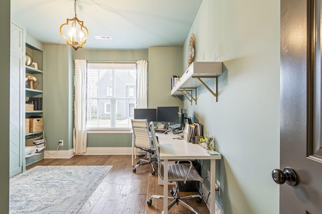 office with visible vents, baseboards, an inviting chandelier, and wood finished floors