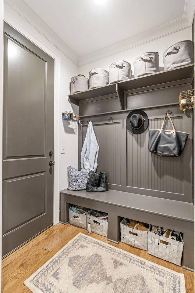 mudroom featuring wood finished floors and ornamental molding