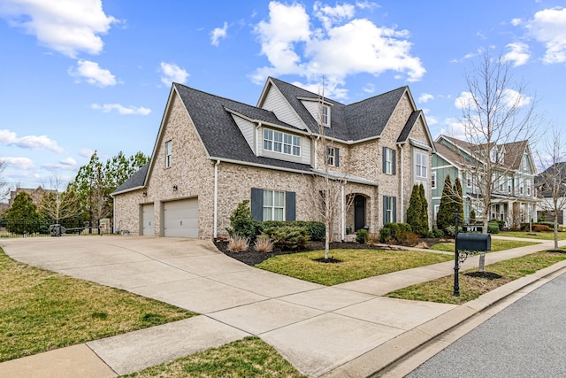 view of front of house with driveway, a front lawn, roof with shingles, an attached garage, and brick siding