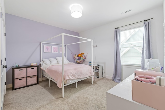 bedroom featuring visible vents, baseboards, and light carpet