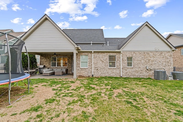 back of property with a ceiling fan, a patio, a trampoline, cooling unit, and outdoor lounge area