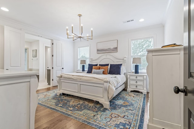 bedroom featuring visible vents, crown molding, recessed lighting, light wood-style floors, and a notable chandelier