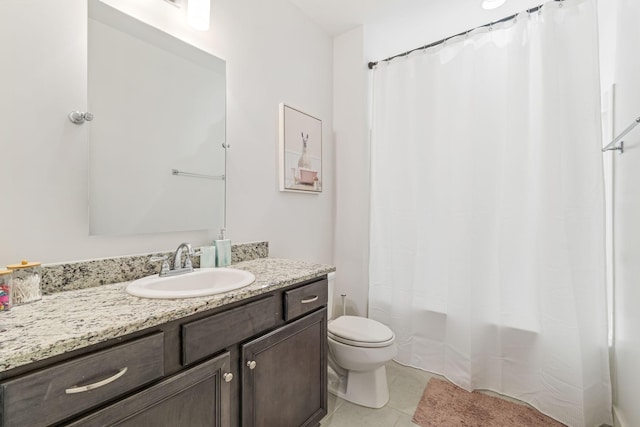 bathroom featuring tile patterned flooring, shower / tub combo, toilet, and vanity