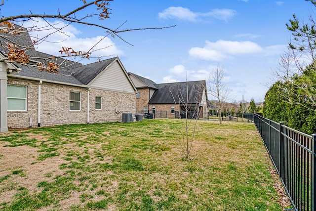 view of yard with central air condition unit and a fenced backyard