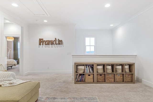 sitting room with attic access, carpet, and ornamental molding