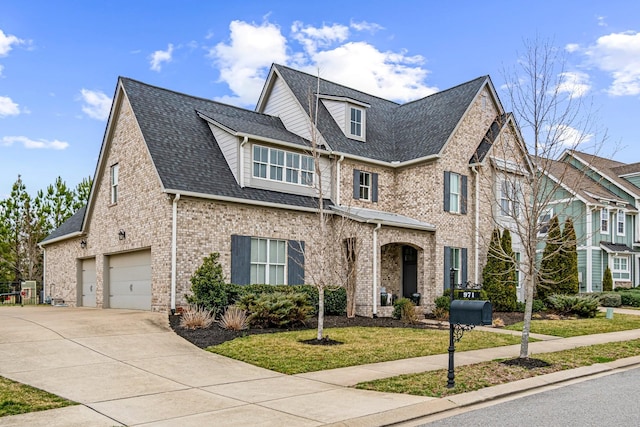 view of front facade with brick siding, a shingled roof, concrete driveway, a front yard, and an attached garage