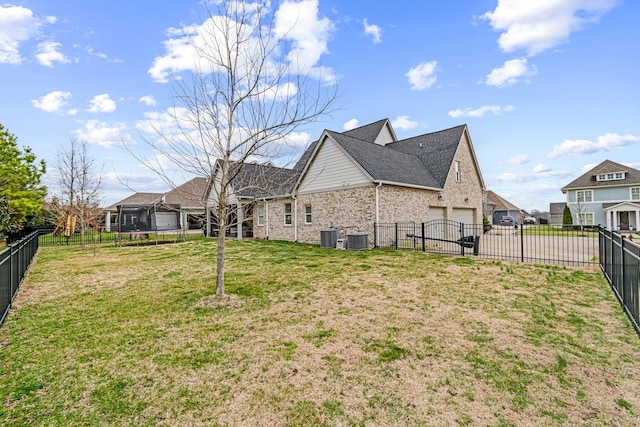 exterior space featuring a yard, a trampoline, central AC, and fence private yard