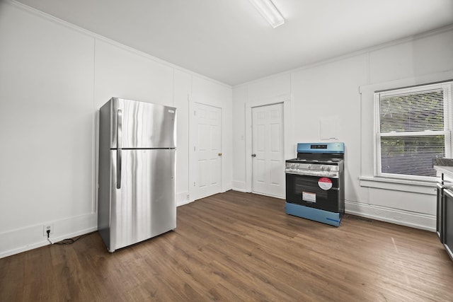 kitchen featuring ornamental molding, dark wood-style floors, and appliances with stainless steel finishes
