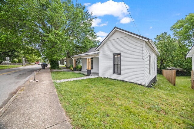 bungalow with fence, a porch, metal roof, and a front yard