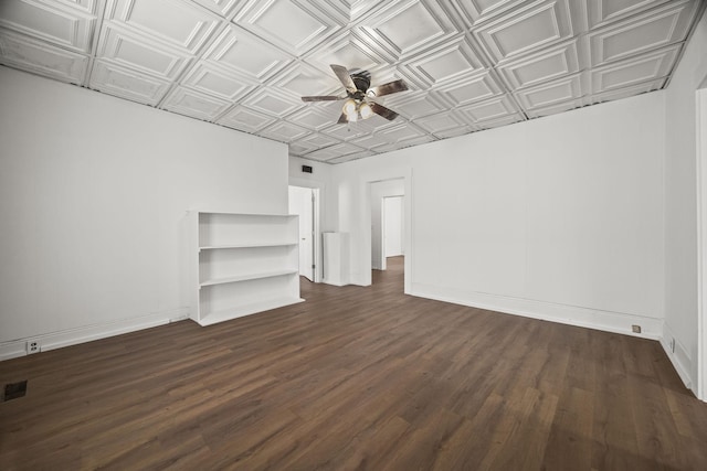unfurnished living room featuring dark wood finished floors, an ornate ceiling, a ceiling fan, and baseboards