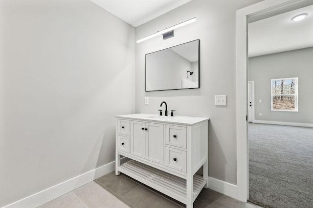 bathroom featuring tile patterned flooring, vanity, and baseboards