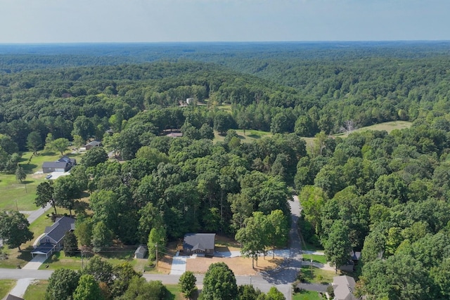 birds eye view of property featuring a view of trees