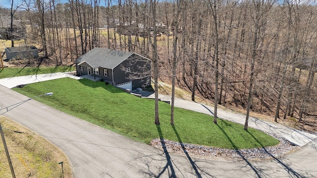 birds eye view of property with a wooded view