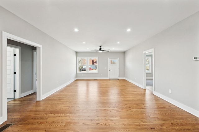 unfurnished living room with visible vents, recessed lighting, light wood-type flooring, and baseboards