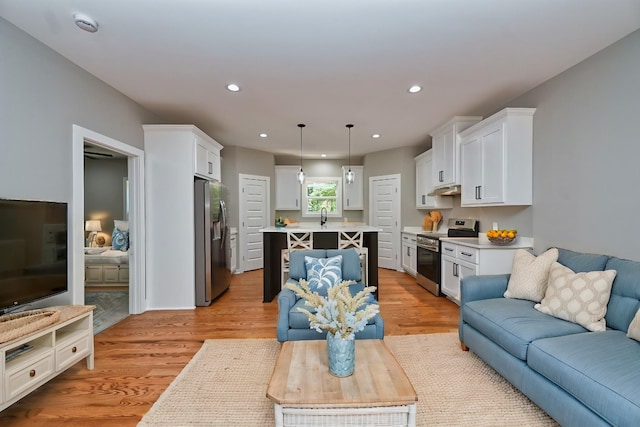 living room with recessed lighting and light wood-type flooring