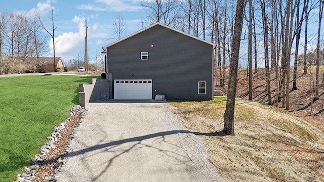 view of side of property with gravel driveway, a yard, and a garage