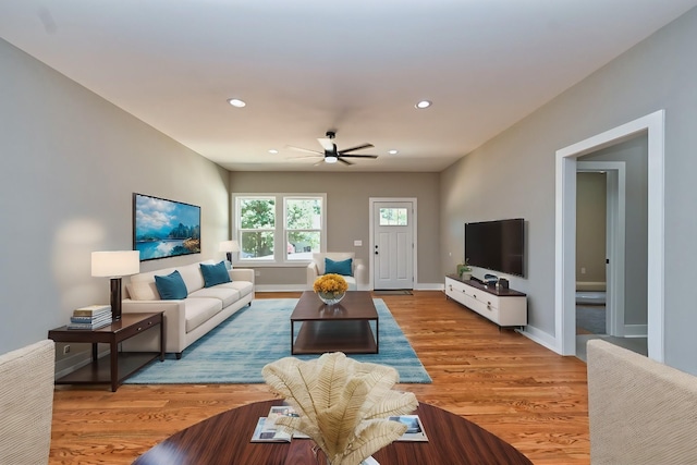 living area with recessed lighting, baseboards, a ceiling fan, and light wood finished floors