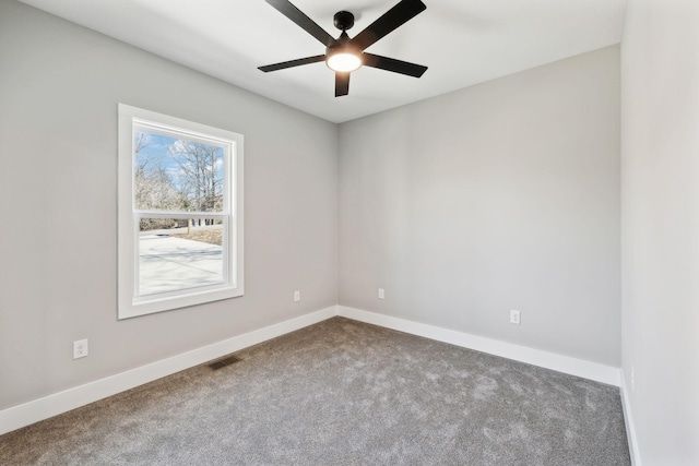 spare room featuring visible vents, a ceiling fan, carpet, and baseboards