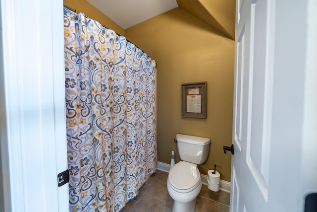 bathroom with curtained shower, tile patterned floors, toilet, and baseboards