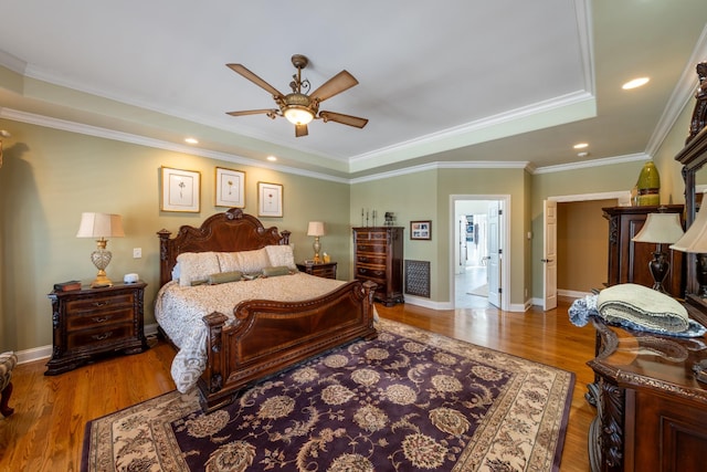 bedroom with recessed lighting, crown molding, baseboards, and wood finished floors