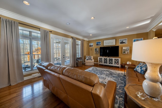 living area with crown molding, baseboards, recessed lighting, french doors, and wood finished floors