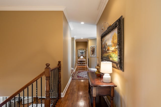 hall featuring an upstairs landing, ornamental molding, wood finished floors, recessed lighting, and baseboards