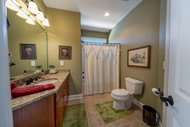 bathroom featuring vanity, tile patterned floors, toilet, and baseboards