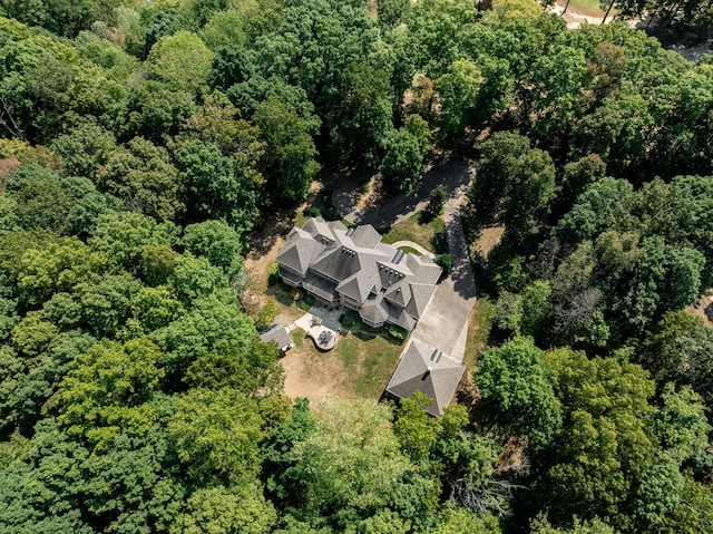 birds eye view of property featuring a view of trees