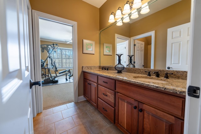 bathroom featuring double vanity, tile patterned floors, baseboards, and a sink