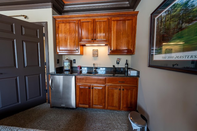 kitchen with dark stone countertops, brown cabinets, ornamental molding, and freestanding refrigerator