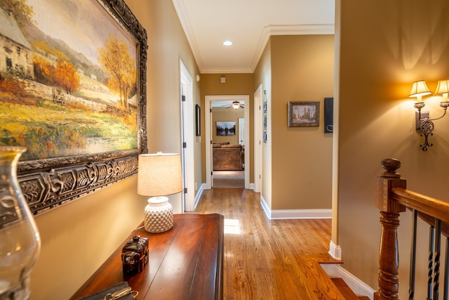 corridor featuring an upstairs landing, ornamental molding, wood finished floors, recessed lighting, and baseboards