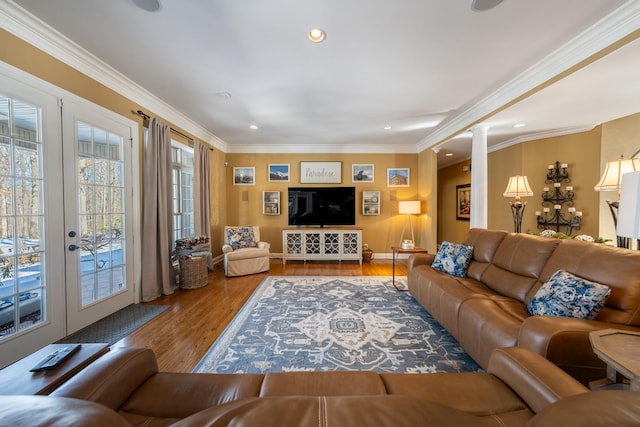 living room featuring crown molding, recessed lighting, french doors, wood finished floors, and ornate columns